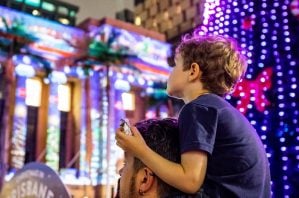 The Lott City Hall Lights event image of boy on hos dads shoulders watching the christmas lights.