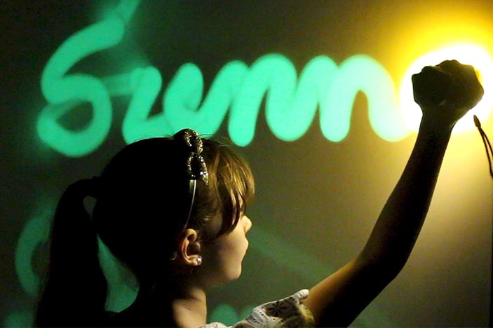 Girl writing name with torch