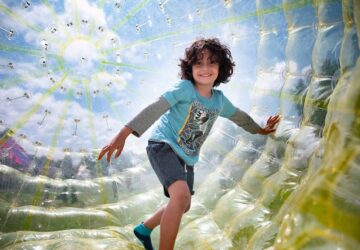 moreton kids festival event image of boy inside vortex ball.