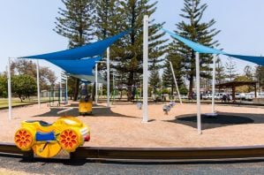 Pratten Park Broadbeach playground with monorail track and shade structures.