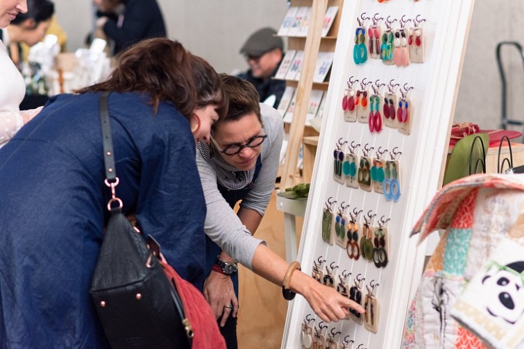 BrisStyle Earing Market event image of two women looking at a wall full of earrings.