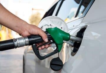 Hand holding a petrol pump.