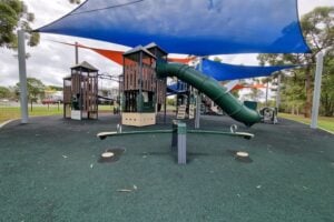 Seesaw and playground with shade sails at Ducie Street Park.