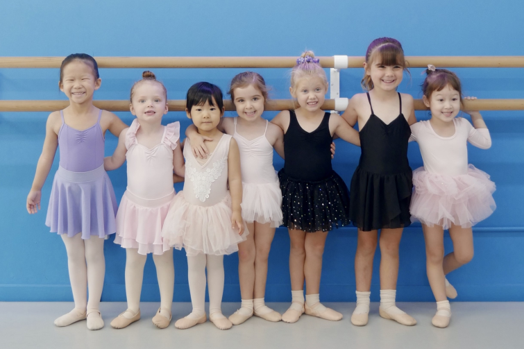 Radiance Dance group of young ballet students at barre.