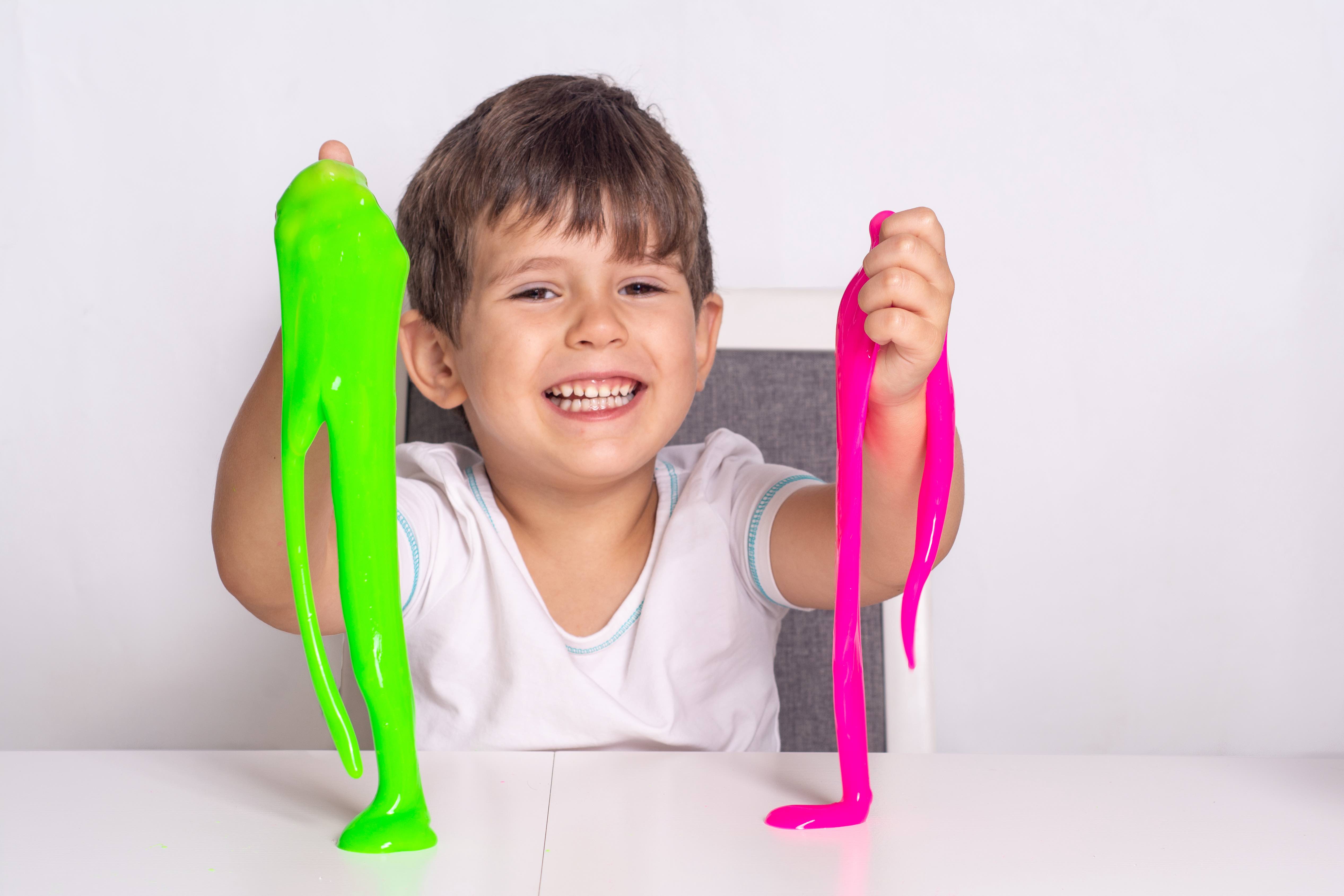 Boy,Play,With,Slime.,Kid,Squeeze,And,Stretching,Toy,Slime.