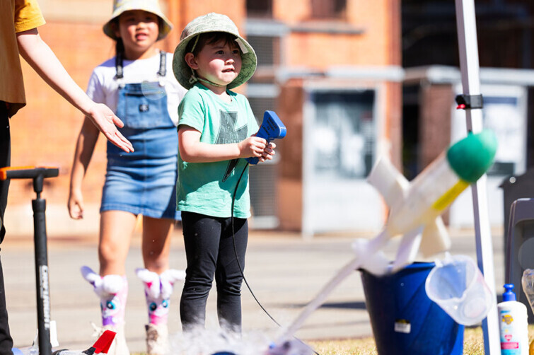 World Science Community Day Ipswich event image of girl launching rocket.