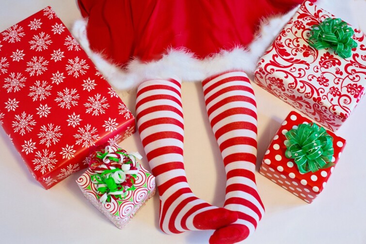 Jingles in July event image of elf and presents.