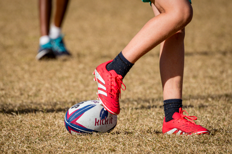 Kick It 4 Kids legs and football.