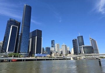 Brisbane City skyline with Brisbane River in foreground.
