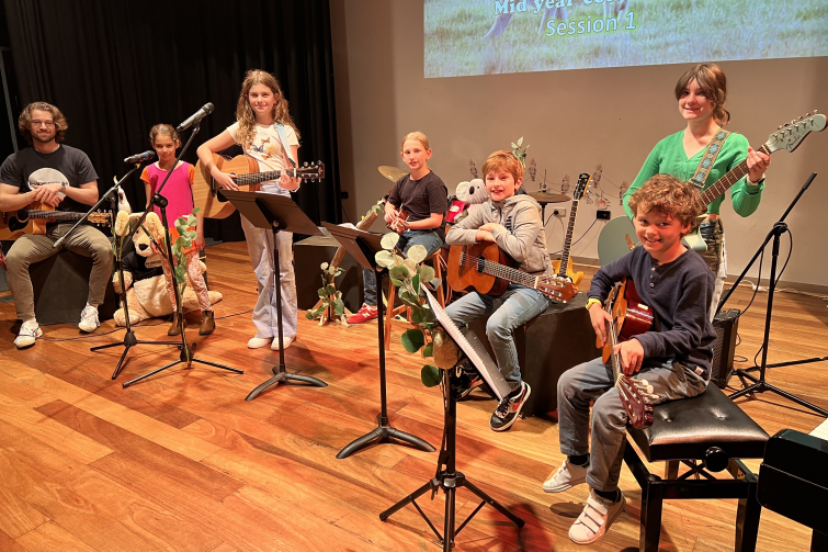 Downtown Creative Studios child musicians on stage.