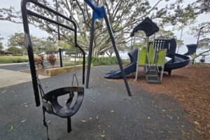 Adult swing and toddler fort at Brennan Park.
