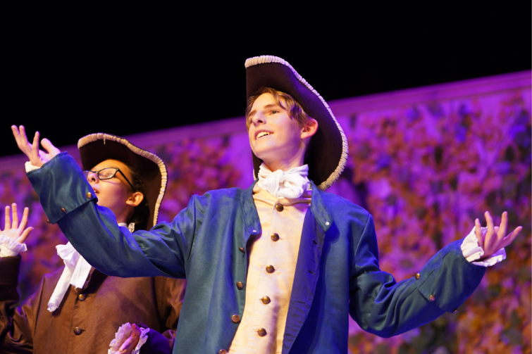 Stage School Australia performers on stage in period costumes.