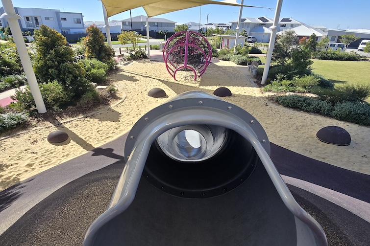 Tunnel slide and nets under shade sails at the Whale Park in Aura.