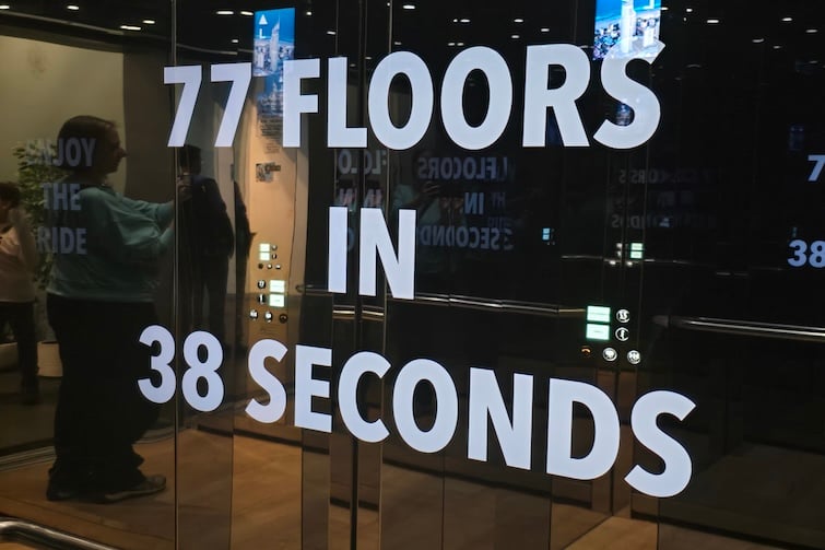 77 floors in 38 seconds sign in the elevator at SkyPoint Observation Deck.