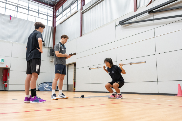 Sharks Volleyball Coaching teen poys lifting weights.