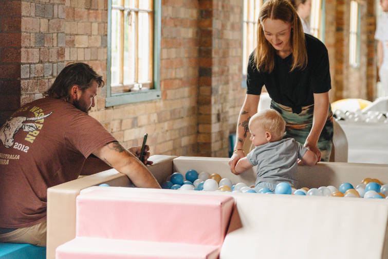 The Hills of Rivermakers baby in ballpit with parents.