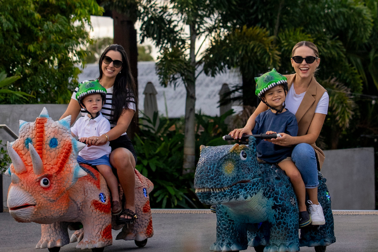 The Hills of Rivermakers kids and mums on dinosaurs.