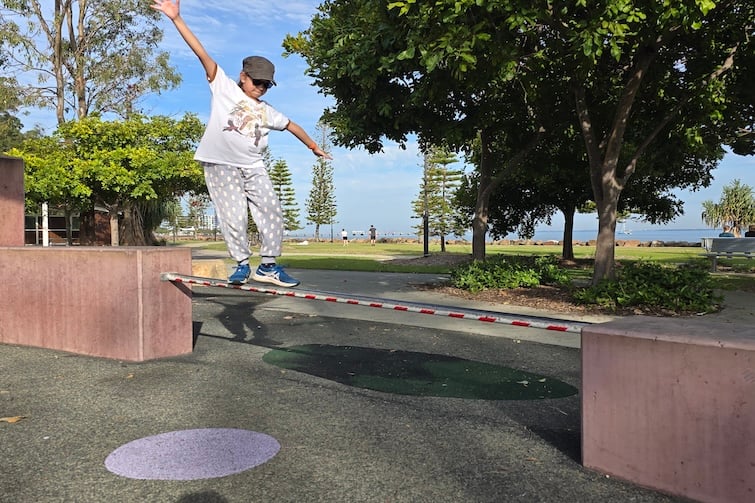Girl balancing on a rail at Redcliffe Parkour Park.