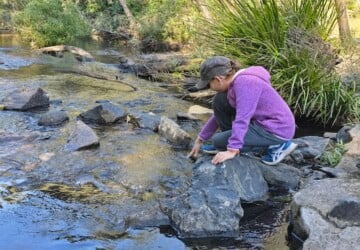 Girl touching the creek water near Kumbartcho Sanctuary.