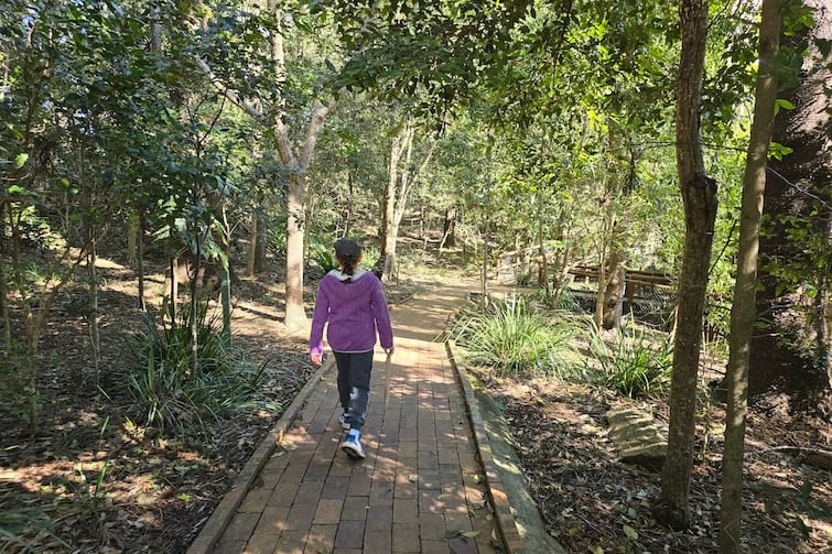 Girl walking on path at Kumbartcho Sanctuary.