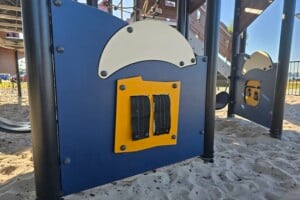 Low to ground play panels in the sand at Pelican Park.