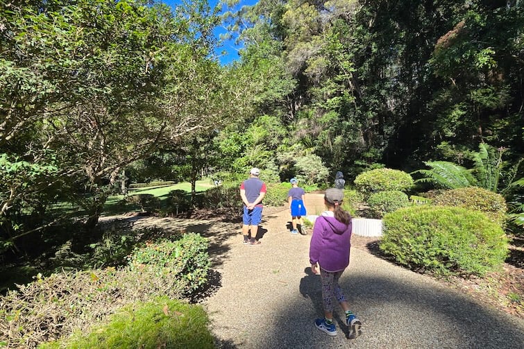Family wandering in the sculpture garden at Maroochy Bushland Botanic Garden.