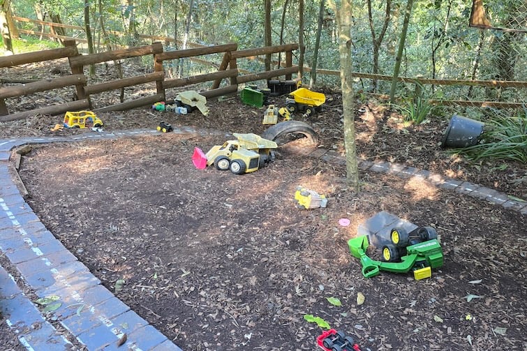 Toy trucks in fairy garden at Kumbartcho Sanctuary.