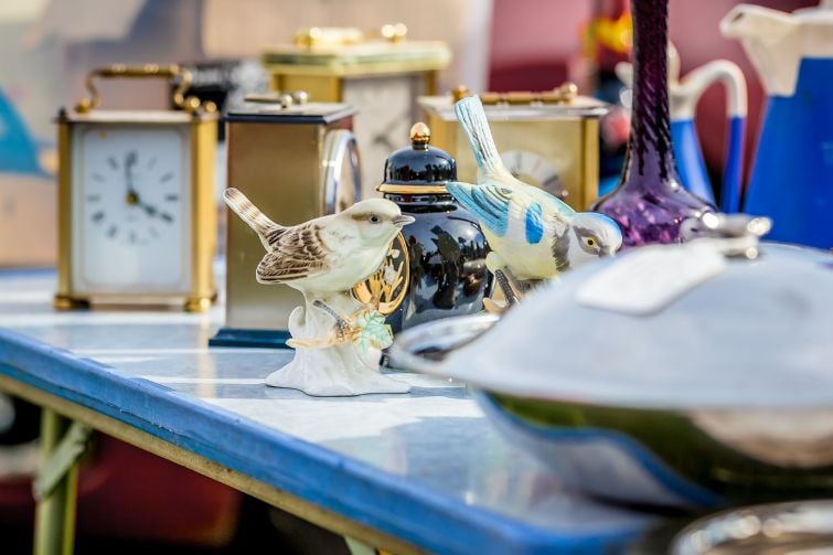 Second hand goods on a table at a car boot sale.