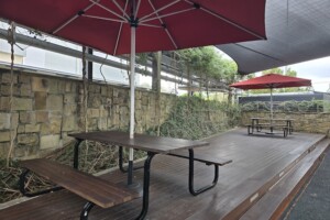 Picnic tables and umbrellas at Westfield North Lakes play area.