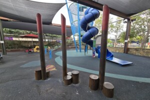 Stepping logs and play equipment at Westfield North Lakes play area.