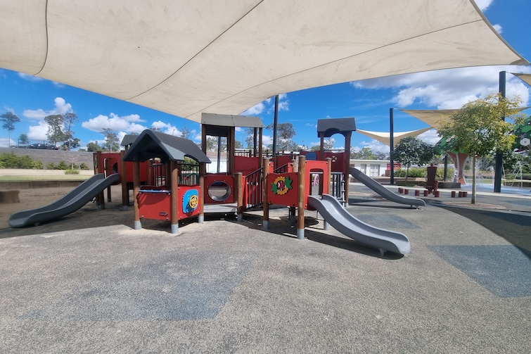 Toddler play area under shade sails at Flagstone Adventure Playground.