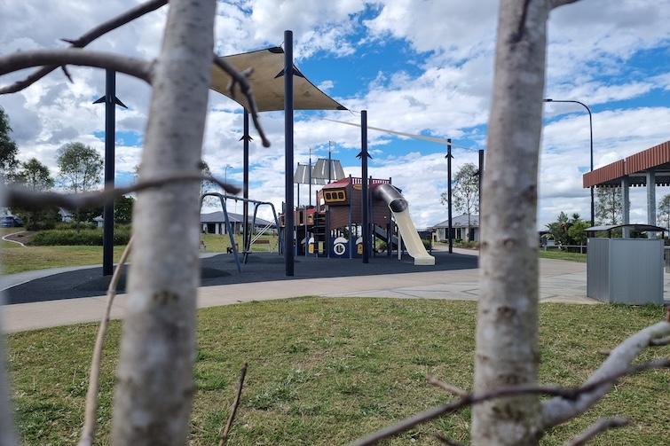View of Flagstone Pirate Park between two trees.