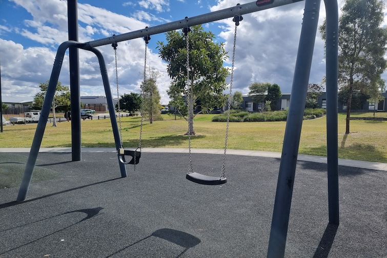 Toddler and standard swing at Flagstone Pirate Park.