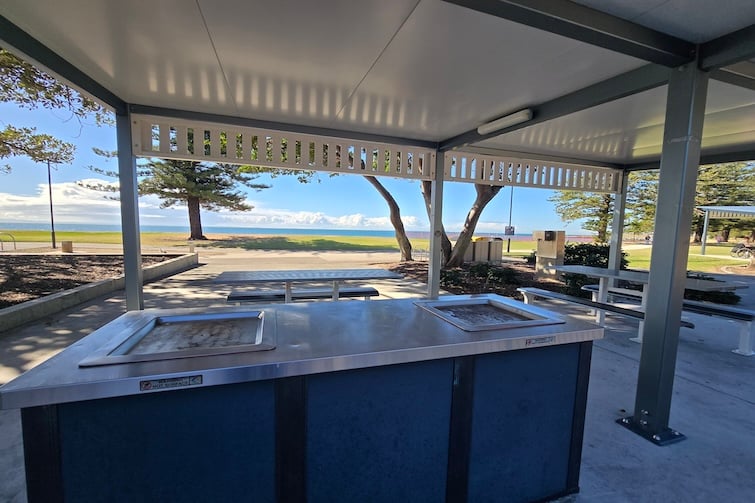BBQ's and picnic tables under the shelters outside Scarborough Beach Park.