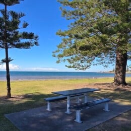 Picnic table with views of the beach outside Scarborough Beach Park.