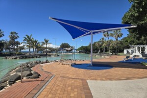 Shade sails and lifesaver chair beside Settlement Cove Lagoon in Redcliffe.
