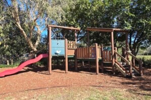 Wooden fort at the fully fenced playground at Einbunpin Lagoon Parklands at Sandgate.