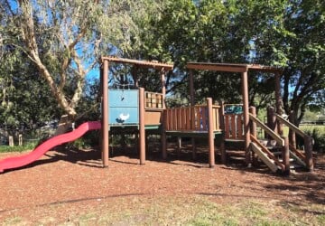 Wooden fort at the fully fenced playground at Einbunpin Lagoon Parklands at Sandgate.