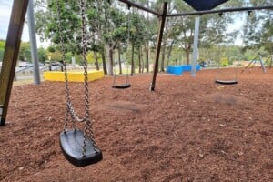 Swings in the playground at Upper Kedron Recreation Reserve.