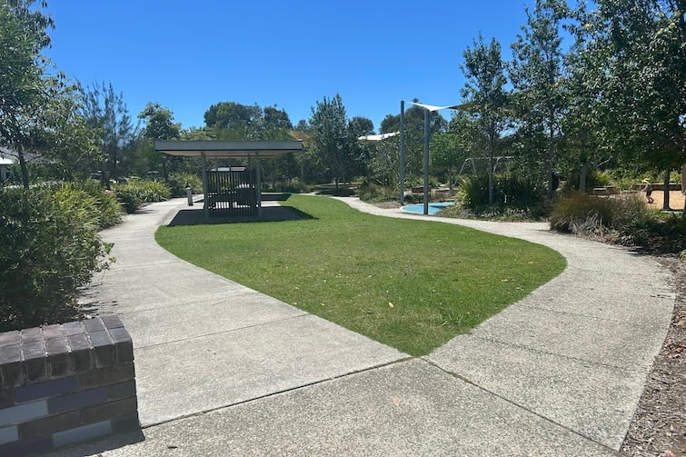 Grassed area and pathways at Eagle Tree Park in Coomera.