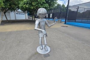 A metal sculpture of a person dancing at Frew Park.
