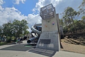 Concrete play structures and twisty tunnel slide at Frew Park.