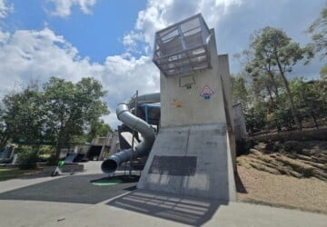 Concrete play structures and twisty tunnel slide at Frew Park.
