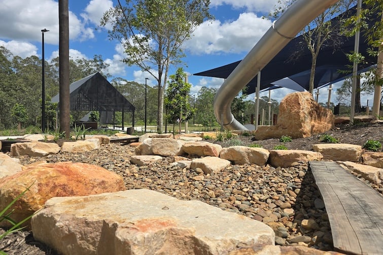 Dy creek bed and metal tunnel slide at Glider Park in Morayfield.