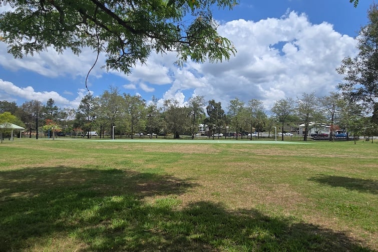 Grassed space and courts at Milton Park.