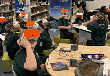 Virtual Science incursions class with VR headsets in library.