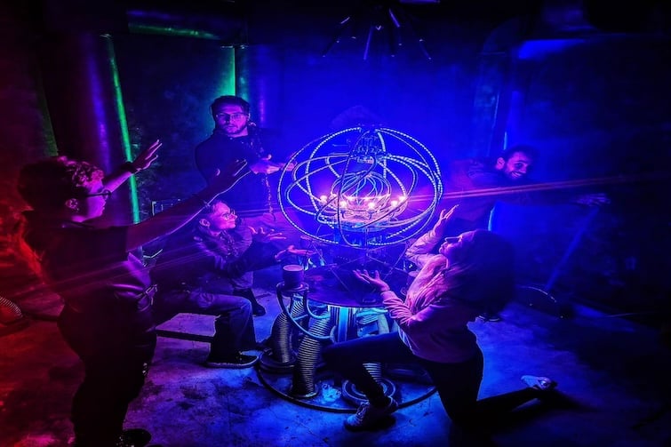 Several people in an escape room at Project Immersive Escape Rooms.