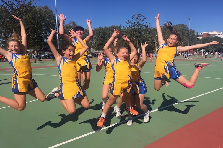 Aspley Devils Netball Club players jumping in the air.
