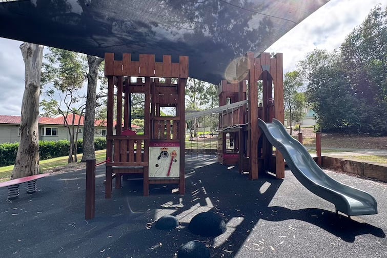 Fort with slide under shade sails at Majestic Park.