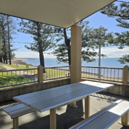 Picnic table with a view of the water at Rotary Park (Amity Playground) in Redcliffe.
